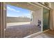 View of the back patio and yard from inside through sliding glass doors at 9815 Evergreen Pine St, Las Vegas, NV 89166