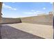 The backyard is dirt and surrounded by a block wall for privacy at 9815 Evergreen Pine St, Las Vegas, NV 89166
