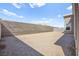 Spacious backyard featuring gravel landscaping, a block wall, and view of the home's exterior siding at 9815 Evergreen Pine St, Las Vegas, NV 89166