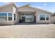 The modern home has a covered patio and dirt area for landscaping at 9815 Evergreen Pine St, Las Vegas, NV 89166