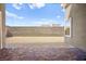 A brick patio, block wall, and dirt comprise this backyard space at 9815 Evergreen Pine St, Las Vegas, NV 89166