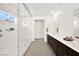 Sleek bathroom boasts a walk-in shower, double vanity with modern fixtures, and bright natural light at 9815 Evergreen Pine St, Las Vegas, NV 89166