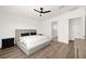 Comfortable bedroom with neutral tones, wood floors, and a minimalist design with a ceiling fan at 9815 Evergreen Pine St, Las Vegas, NV 89166