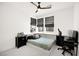 Well-lit bedroom with built-in shelves above the bed, two windows, and a ceiling fan at 9815 Evergreen Pine St, Las Vegas, NV 89166