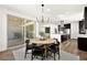 Open concept dining area with access to the kitchen and outdoor patio, perfect for entertaining at 9815 Evergreen Pine St, Las Vegas, NV 89166