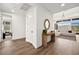 Bright entryway featuring hardwood floors, modern decor, and an open view into the spacious living area at 9815 Evergreen Pine St, Las Vegas, NV 89166