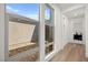 Hallway view featuring large windows, light filled space, and connecting doors at 9815 Evergreen Pine St, Las Vegas, NV 89166