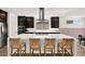 Modern kitchen with a large island, seating, and stainless steel appliances at 9815 Evergreen Pine St, Las Vegas, NV 89166