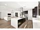 Open kitchen with a modern island that flows into the living room area at 9815 Evergreen Pine St, Las Vegas, NV 89166