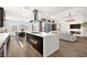 Bright open floor plan showcasing a modern kitchen with a large island and stainless steel appliances at 9815 Evergreen Pine St, Las Vegas, NV 89166