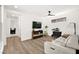 Cozy living room features neutral paint, wood flooring and a wall-mounted television set at 9815 Evergreen Pine St, Las Vegas, NV 89166