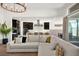 Bright, open-concept living room and kitchen with modern finishes and large sectional sofa at 9815 Evergreen Pine St, Las Vegas, NV 89166