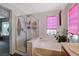Bright bathroom featuring a shower, soaking tub, and plants at 1007 Shades End Ave, North Las Vegas, NV 89081