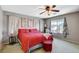 Comfortable bedroom with a ceiling fan, carpet flooring, and natural light from the window at 1007 Shades End Ave, North Las Vegas, NV 89081