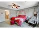 Spacious bedroom with a ceiling fan, carpet flooring, and ample natural light at 1007 Shades End Ave, North Las Vegas, NV 89081