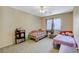 Bedroom featuring two twin beds, a ceiling fan, and plenty of natural light at 1007 Shades End Ave, North Las Vegas, NV 89081