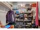 Organized walk-in closet with shelving and hanging space for clothing and accessories at 1007 Shades End Ave, North Las Vegas, NV 89081