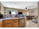 Open concept: kitchen with tile and living room with nice sofa and other seating at 1007 Shades End Ave, North Las Vegas, NV 89081