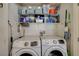 Convenient laundry room equipped with modern Samsung washer and dryer, and ample shelving at 1007 Shades End Ave, North Las Vegas, NV 89081