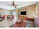 Inviting living room featuring tile floors, a ceiling fan, and access to the backyard patio at 1007 Shades End Ave, North Las Vegas, NV 89081