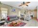 Bright living room showcasing tile flooring, comfortable seating, and access to the staircase, perfect for relaxation at 1007 Shades End Ave, North Las Vegas, NV 89081