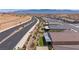 Scenic aerial shot of a desert community, complete with sidewalks, lush landscaping, and mountain views at 1047 Atkins Ln, Mesquite, NV 89027