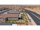 Expansive aerial view of a desert community, highlighting desert landscaping and a mountain backdrop at 1047 Atkins Ln, Mesquite, NV 89027