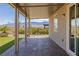 Covered back patio featuring brick pavers and well-maintained synthetic grass with mountain views at 1047 Atkins Ln, Mesquite, NV 89027