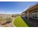 Landscaped backyard with artificial turf, stone, and a covered patio at 1047 Atkins Ln, Mesquite, NV 89027