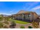 The backyard has desert landscaping, artificial turf, and a covered patio, ideal for outdoor living at 1047 Atkins Ln, Mesquite, NV 89027