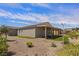 Low maintenance backyard with desert landscaping, artificial turf, and a covered patio at 1047 Atkins Ln, Mesquite, NV 89027