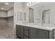 Bathroom with a double sink vanity, large mirror and walk-in closet at 1047 Atkins Ln, Mesquite, NV 89027