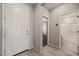 Bright entryway with wood-look floors, a white door, and access to the bathroom and bedroom at 1047 Atkins Ln, Mesquite, NV 89027