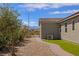 Side view of the house features a tiled roof, desert landscaping, and a stone pathway at 1047 Atkins Ln, Mesquite, NV 89027