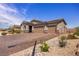 Beautiful single story home showcasing desert landscaping, stone accents, and a brick driveway at 1047 Atkins Ln, Mesquite, NV 89027