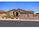 Charming home featuring desert landscaping, a three-car garage, and a paved driveway at 1047 Atkins Ln, Mesquite, NV 89027