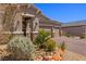 Landscaped front yard with desert plants, a three-car garage, and stone accents on the facade at 1047 Atkins Ln, Mesquite, NV 89027
