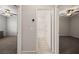 Hallway view showing access to bathroom with glass shower and two carpeted bedrooms at 1047 Atkins Ln, Mesquite, NV 89027
