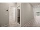 Bright hallway with wood-look tile, leading to bathroom with glass shower and bedroom at 1047 Atkins Ln, Mesquite, NV 89027