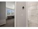 Hallway featuring a modern thermostat and access to a full bathroom and bedroom with a desk at 1047 Atkins Ln, Mesquite, NV 89027