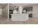 Bright kitchen features modern grey cabinets, recessed lights and a kitchen island with bar seating at 1047 Atkins Ln, Mesquite, NV 89027
