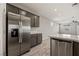 Bright open kitchen with stainless steel refrigerator and modern gray cabinets at 1047 Atkins Ln, Mesquite, NV 89027