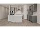 Bright kitchen features modern grey cabinetry, recessed lights and an island with bar seating at 1047 Atkins Ln, Mesquite, NV 89027