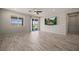 Bright living room with wood-look tile floors, ceiling fan and slider access to the backyard at 1047 Atkins Ln, Mesquite, NV 89027