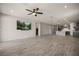 Bright living room features wood-look tile floors, recessed lights and a ceiling fan at 1047 Atkins Ln, Mesquite, NV 89027