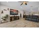Comfortable living room featuring a ceiling fan, tv, and wood-look tile floors at 1047 Atkins Ln, Mesquite, NV 89027