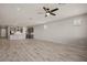 Spacious open-concept living room and kitchen with recessed lights and wood-look tile flooring at 1047 Atkins Ln, Mesquite, NV 89027
