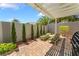 Paver patio with lounge chairs, grill, and privacy landscaping is perfect for relaxing or entertaining at 10579 Garden Rose Dr, Las Vegas, NV 89135