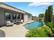 Private backyard oasis with a sparkling pool, comfortable seating, and beautiful landscaping for ultimate relaxation at 10579 Garden Rose Dr, Las Vegas, NV 89135