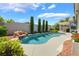 Backyard oasis with a waterfall feature, sparkling pool, and lush landscaping is ideal for outdoor relaxation at 10579 Garden Rose Dr, Las Vegas, NV 89135
